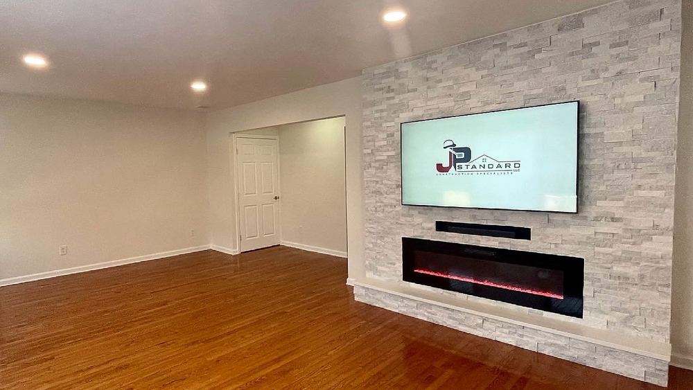 Living room with stone fireplace wall on Riverside Drive